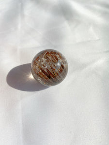 Illuminating Red Rutilated Quartz Sphere