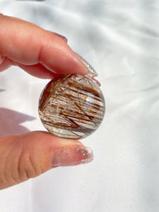 Illuminating Red Rutilated Quartz Sphere